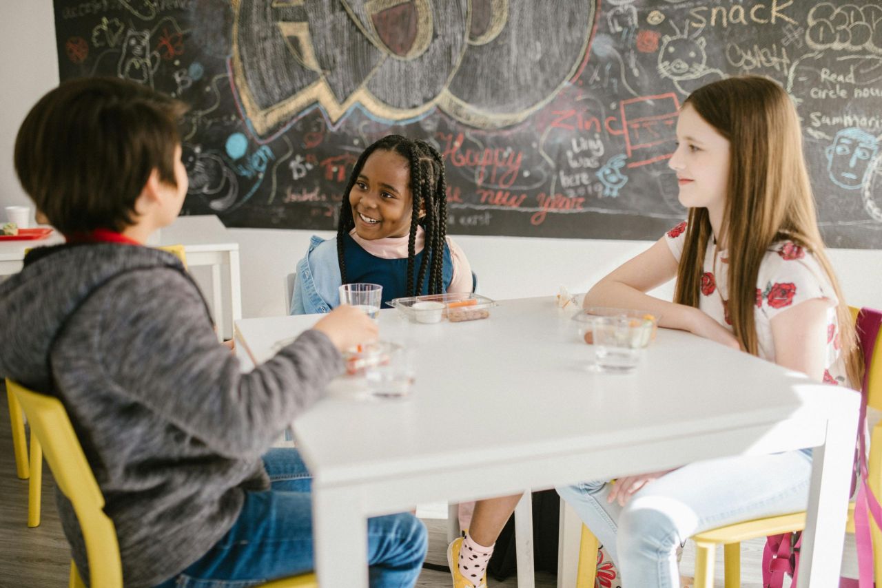 Children sitting at a table together.