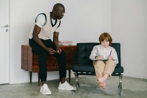Man teaching a young boy.