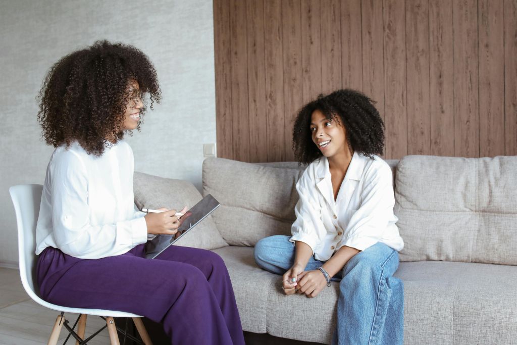 An adult talking to a student.