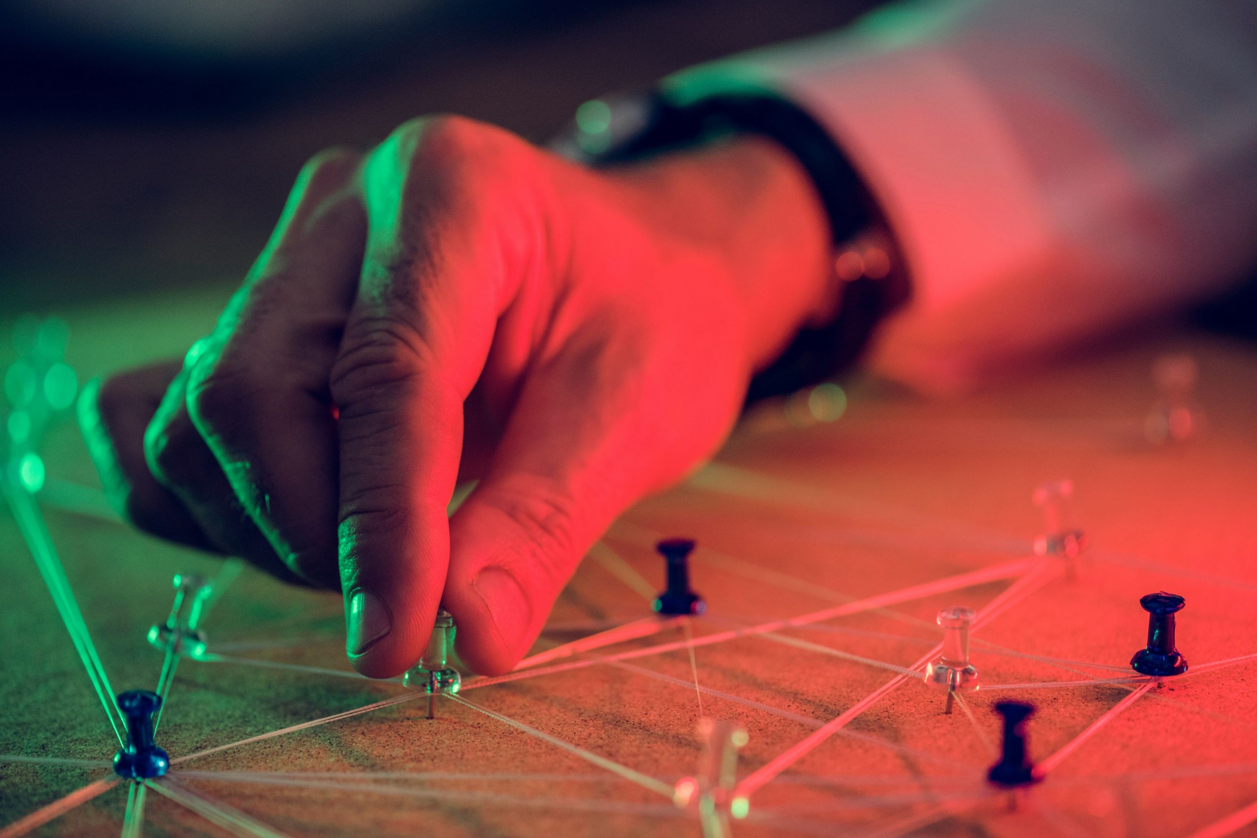 Person placing pushpins onto a map.