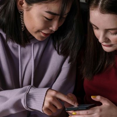 Two students looking at a phone.