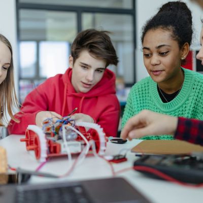 Students working on a science/robotics project together,