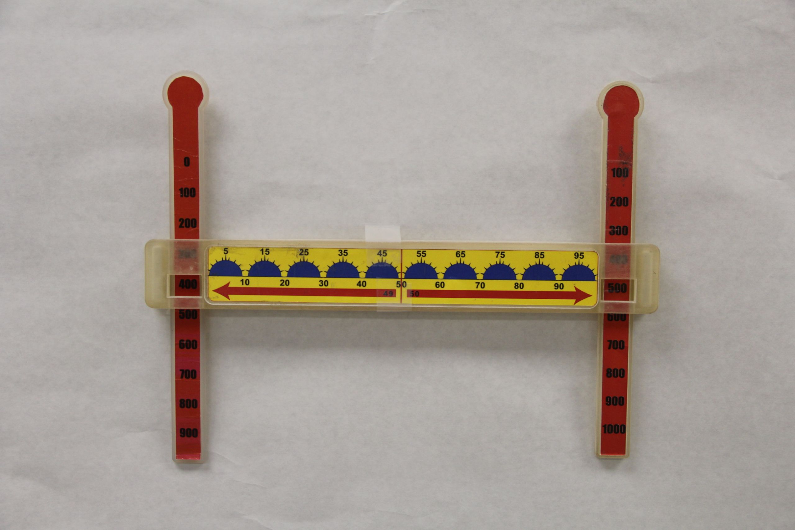 Third Prototype yellow math manipulative with green half circles along the line and red handles on the ends