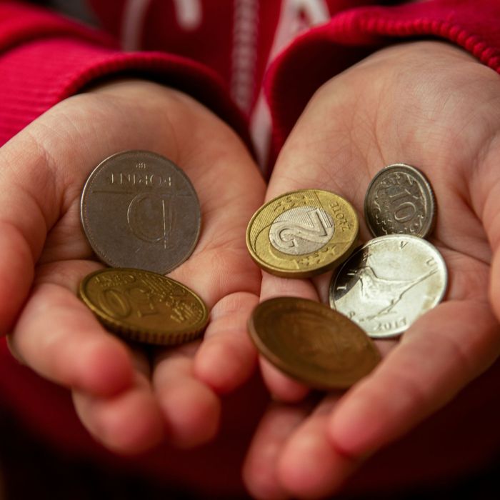 Child's hands holding assorted coins