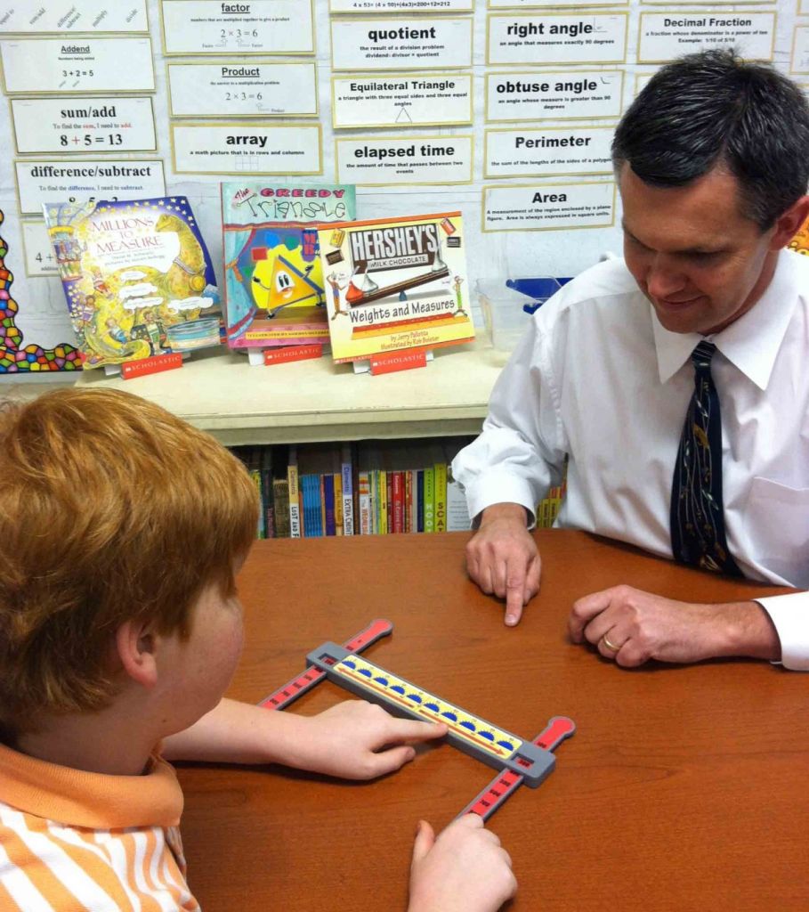 Author working with student with math manipulative