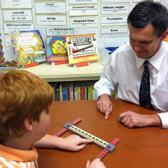 Author working with student with math manipulative