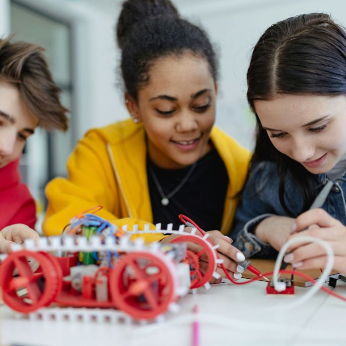 3 students working on robot in STEM class