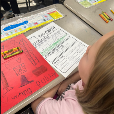 student at desk with worksheet on desk