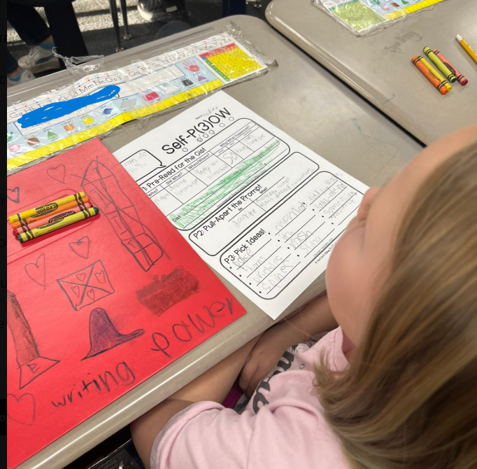 student at desk with worksheet on desk
