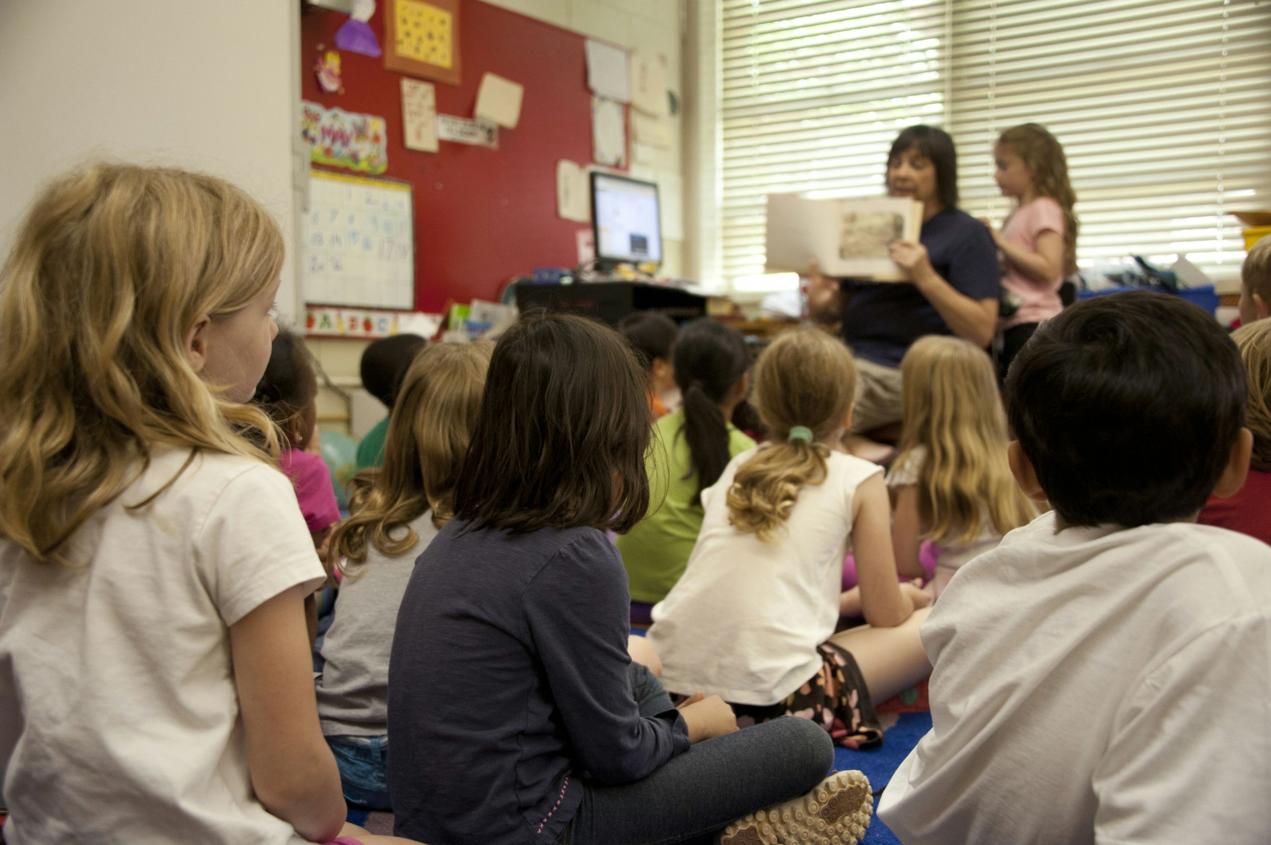 Teacher reading to a group of students Teacher reading to a group of students