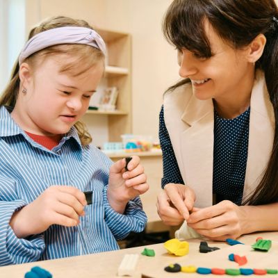 Student with Downs Syndrome working with a teacher