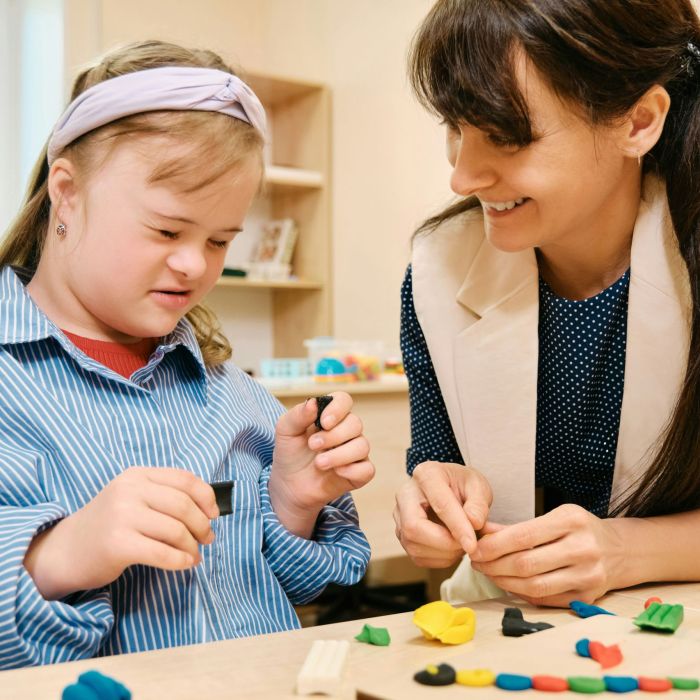 Student with Downs Syndrome working with a teacher