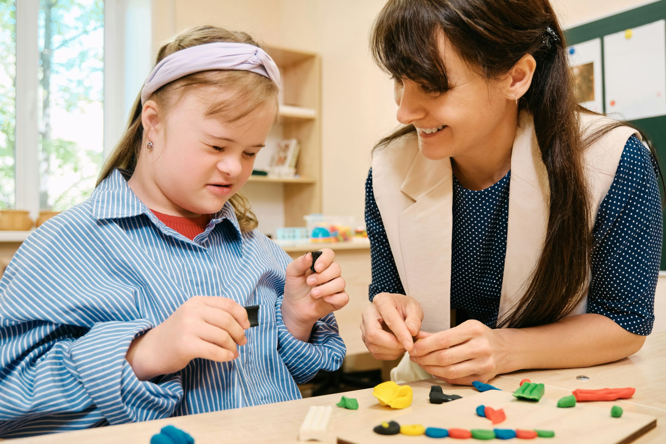 Student with Downs Syndrome working with a teacher