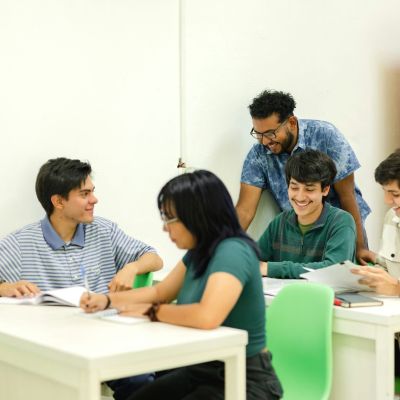 5 adults working together at 2 tables