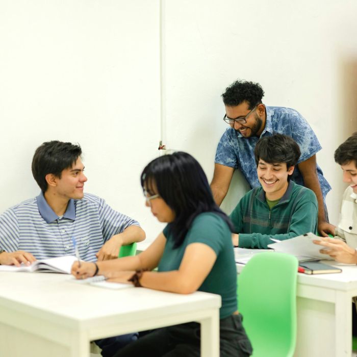 5 adults working together at 2 tables