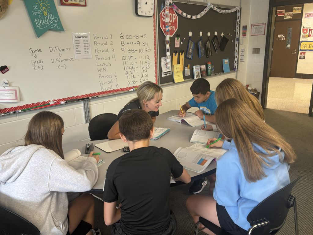 Teacher working with students